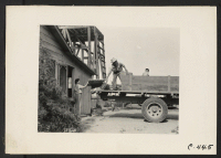 [recto] Woodland, Calif.--Preparations are being made to evacuate this farm on the following morning. The neighbor has come with his truck to assist his friends of Japanese ancestry inasmuch as the father has been interned in South Dakota. ;  Photographer: Lang