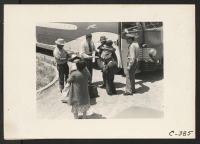 [recto] Stockton, Calif.--People of Japanese ancestry from the Lodi grape producing district. Their identification numbers and family groups are checked by ...