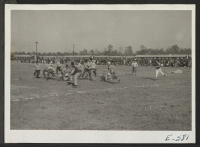 [recto] Football crowd at game between group teams at this center, organized to provide sports event participation and general center recreation. ;  Photographer: Lynn, Charles R. ;  Denson, Arkansas.