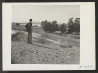[recto] In the foreground can be seen the irrigation canal which will supply Poston with agricultural water. This canal receives its water from the Parker Dam. In the background can be seen the Colorado River. ;  Photographer: Stewart, Francis ;  Poston, Ariz