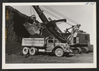 [recto] Loading trucks with lava rock. ;  Photographer: Cook, John D. ;  Newell, California.