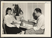 [recto] George Stanicci, formerly of the Manzanar Relocation Center, is sketching his wife, the former Miss Margaret Ichino also of Manzanar, ...