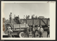 [recto] Coal loading machine in operation at Granada Relocation Center. ;  Photographer: McClelland, Joe ;  Amache, Colorado.
