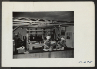 [recto] The kitchen section at work preparing dinner for Block 7, in the early afternoon. ;  Photographer: Parker, Tom ;  Denson, Arkansas.