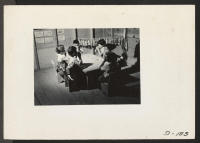 [recto] Nursery school children pause for refreshments of graham crackers and milk. ;  Photographer: Stewart, Francis ;  Newell, California.