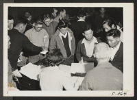 [recto] Byron, California--Three days before evacuation these people of Japanese ancestry are receiving their final instructions at the WCCA station in this agricultural community. ;  Photographer: Lange, Dorothea ;  Byron, California.