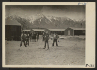 [recto] Manzanar, Calif.--Boys start a ball game soon after their arrival at Manzanar, now a War Relocation Authority center for evacuees of Japanese ancestry. ;  Photographer: Albers, Clem ;  Manzanar, California.