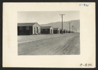 [recto] Manzanar, Calif.--Street scene of barrack homes at this War Relocation Authority center for evacuees of Japanese ancestry. ;  Photographer: Lange, Dorothea ;  Manzanar, California.