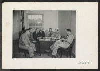 [recto] Ray D. Johnston, Project Director, in conference with the staff. ;  Photographer: Parker, Tom ;  McGehee, Arkansas.