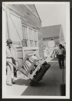 [recto] Evacuees loaded their own freight on train. ;  Newell, California.
