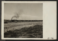 [recto] Eden, Idaho--A train bringing approximately six hundred evacuees from the assembly center at Puyallup, Washington. Busses, used to transport these people to the Minidoka War Relocation Authority center, are waiting at the siding. ;  Photographer: Stewar