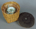 Teapot with lid in wicker basket, padded