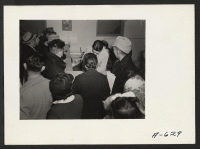 [recto] Absentee voters of Japanese descent getting ballots and having them notarized. ;  Photographer: Stewart, Francis ;  Newell, California.