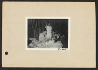 [recto] Poston, Ariz.--First sick man at this War Relocation Authority center for evacuees of Japanese ancestry. (L to R) Head doctor, Leo Schnur, and evacuee doctor, Dr. S. Watoke. ;  Photographer: Clark, Fred ;  Poston, Arizona.