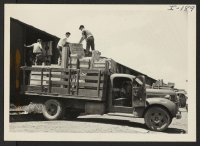[recto] Closing of the Jerome Center, Denson, Arkansas. Loading freight cars with evacuee property to be shipped to the Gila River Center. ;  Photographer: Iwasaki, Hikaru ;  Denson, Arkansas.