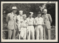 [recto] Before proceeding to the White House for the presentation to President Truman, Sgt. Yeichi Kuwayama shows Dillon Myer, WRA Director, ...