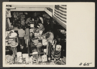 [recto] Customers buy merchandise in a store operated by a proprietor of Japanese ancestry, during a pre-evacuation sale. Evacuees will be housed in War Relocation Authority centers for the duration. ;  Photographer: Lange, Dorothea ;  San Francisco, Californ