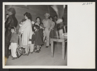 [recto] Many small children and babies were among the 489 arrivals at Tule Lake from Topaz. Some of them are here shown waiting in line to register at the induction center. ;  Photographer: Mace, Charles E. ; , .