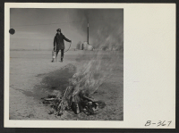 [recto] A demonstration of fire fighting with a stirrup pump is put on by an evacuee member of the fire department. ;  Photographer: Stewart, Francis ;  Topaz, Utah.