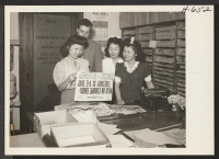 [recto] Mary Kitano from Manzanar works for City New Service in Los Angeles. Holding the paper is Betty Lyou, Korean; next ...