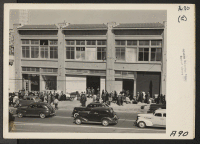 [recto] View of Wartime Civil Control Administration station at 2020 Van Ness Avenue on April 6, 1942, when first group, of ...