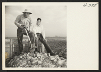 [recto] Miss Rose Tanaka, owner and operator of her own farm near Henderson, Colorado, is shown with Tom Tanabe from Rohwer, ...