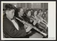[recto] A part of the reed section of the High School band in a practice session. Most of the student band ...