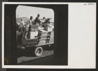 [recto] A truck load of heavy baggage is framed in the baggage of doorway as it leaves the freight yard enroute to the Tule Lake warehouse. ;  Photographer: Mace, Charles E. ; , .