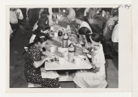 [recto] Lunch time and the workers of the first contingent display healthy appetites. ;  Photographer: Parker, Tom ;  Amache, Colorado.