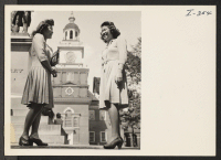 [recto] Dorothy Tanaka and Fuku Yokoyama, who relocated to Philadelphia, Pennsylvania, from the Colorado River Relocation Center in June 1944, are seeing famous Independence Hall and its Liberty Bell for the first time. ;  Photographer: Iwasaki, Hikaru ;  Phi