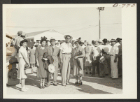 [recto] Left to right: Mr. and Mrs. Tom Yanai of Poston, Tom Takamatsu and [illegible] Takamatsu of Manzanar, ready to board the Rivers-bound bus for first lap of trip to Japan via Grispsholm. Mr. amd Mrs. Yanai, however, returned to Poston. ;  Photographer: Br