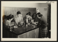 [recto] High school physics class. Harry Williams, instructor, at right. ;  Amache, Colorado.