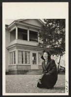 [recto] Mrs. Kay Korematsu, formerly of Tule Lake and Marysville, California, in front of her house on the $135,000 farm that ...