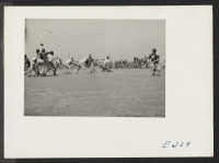 [recto] A football game between teams representing Stockton and Santa Anita. ;  Photographer: Parker, Tom ;  McGehee, Arkansas.