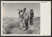 [recto] Newspaper cameramen from the San Francisco newspapers photograph a general view of the Tule Lake Relocation Center. ;  Photographer: Stewart, Francis ;  Newell, California.