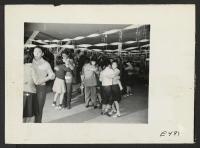[recto] A regular Saturday evening dance at Terry Hall, a mess hall in the school block which has been used for social functions and adult class groups. ;  Photographer: Parker, Tom ;  Amache, Colorado.