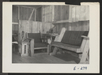 [recto] The chair, table and settee in this barracks home were made by M. Makimoto of 7-06-F. ;  Photographer: Parker, Tom ;  Denson, Arkansas.