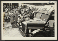 [recto] Closing of the Jerome Center, Denson, Arkansas. Jerome residents who are to be transferred to the Rohwer Center assembled at one or another of the center's messhalls where they are put aboard chartered buses. ;  Photographer: Iwasaki, Hikaru ;  Denson