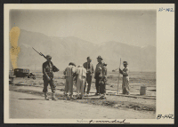 [recto] Time out to talk over the construction of water pipes at this War Relocation Authority center. ;  Photographer: Albers, Clem ;  Manzanar, California.
