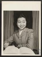 [recto] Sonoko Matsuo, formerly of Minidoka Relocation Center and Seattle, Washington, studies in the Kansas City General Hospital's library. Miss Matsuo ...