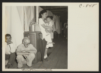 [recto] A typical interior scene in one of the barrack apartments at this center. Note the cloth partition which lends a small amount of privacy. ;  Photographer: Lange, Dorothea ;  Manzanar, California.