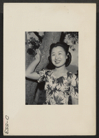 [recto] Manzanar, Calif.--Florence Yamaguchi, from Los Angeles, pictured beneath an apple tree at Manzanar, a War Relocation Authority center where evacuees of Japanese ancestry will spend the duration. ;  Photographer: Stewart, Francis ;  Manzanar, Californi
