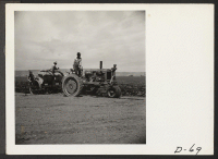 [recto] Tule Lake, Newell, Calif.--A crew of evacuee-farmers planting potatoes with a semi-automatic-feeding, rotary potato planter on the project farm at this War Relocation Authority center. ;  Photographer: Stewart, Francis ;  Newell, California.