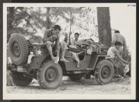[recto] Hot Mississippi. Members of the 442nd combat team drape themselves on a jeep to dress after a cool swim in ...