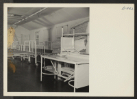 [recto] Closing of the Jerome Center, Denson, Arkansas. Hospital beds and mattresses assembled in one of the wards for shipment to other centers. ;  Photographer: Mace, Charles E. ;  Denson, Arkansas.