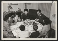 [recto] The Yasamura family and a neighbor boy gather at Sunday dinner. The family includes Mr. Jobu Yasamura, father, an issei, ...