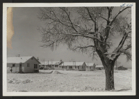 [recto] The administrative living quarters, December, 1943. Note the chimneys coming out of the windows! ;  Photographer: McClelland, Joe ;  Amache, Colorado.