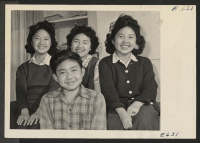 [recto] Four children of the Hifumi family, formerly of Los Angeles, left to right, Helen, 13; Fred, 14; Alice, 17 and Ruby, 16. All attend the Heart Mountain High School. ;  Photographer: Parker, Tom ;  Heart Mountain, Wyoming.