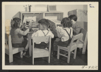 [recto] Children are taught democratic games in the nursery school at this Relocation Center. All desks, chairs, and other furniture are made in the furniture factory, by evacuee workers. ;  Photographer: Stewart, Francis ;  Manzanar, California.