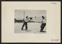 [recto] Manzanar, Calif.--A close play at third base in a practice game between members of the Chick-a-dee softball team. The team ...